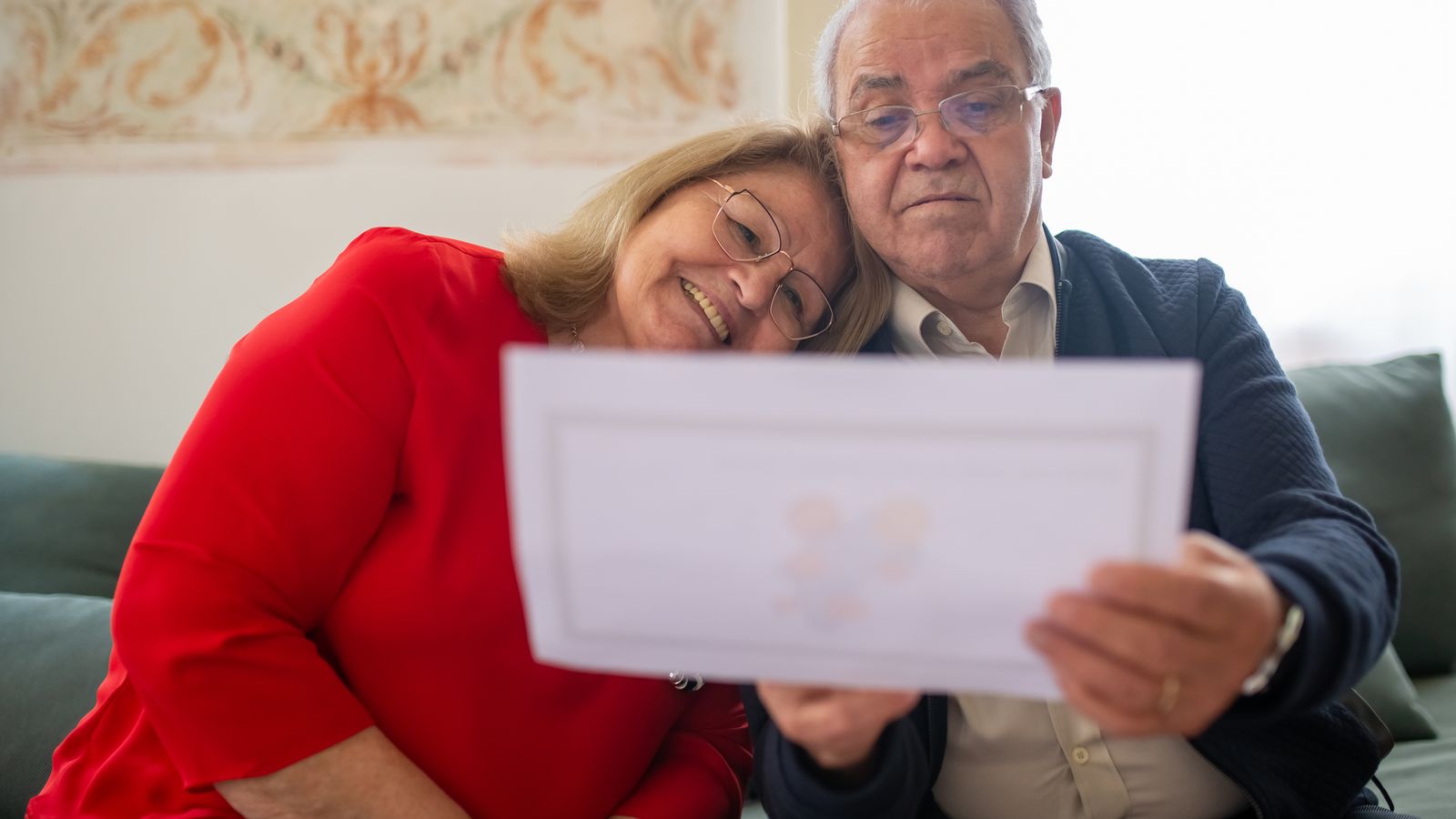 Happy senior Florida couple reviewing Medicare Supplement Medigap documents together at home in 2026