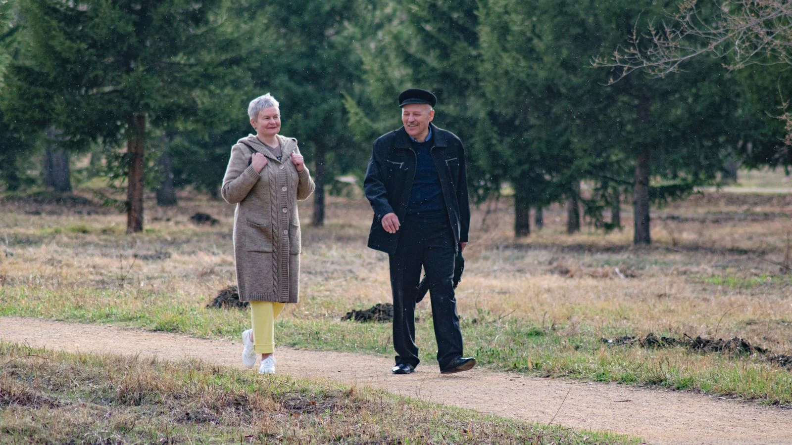 Florida senior couple walking outdoors in fall, planning ahead for the Medicare Annual Enrollment Period 2027