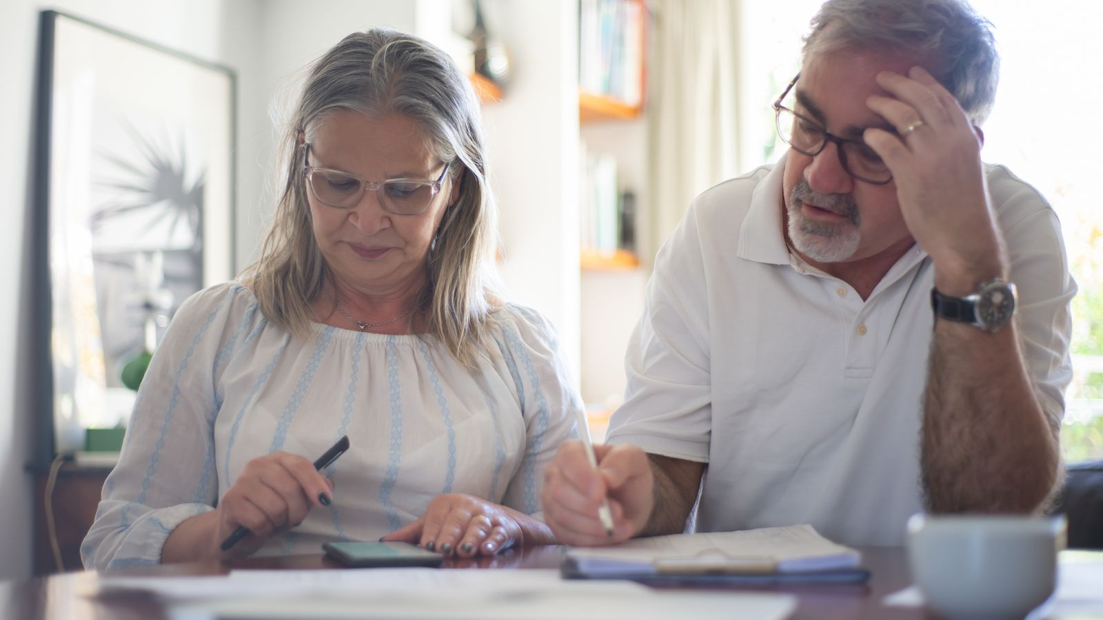 Retired Florida couple reviewing prescription drug costs and their monthly budget at home